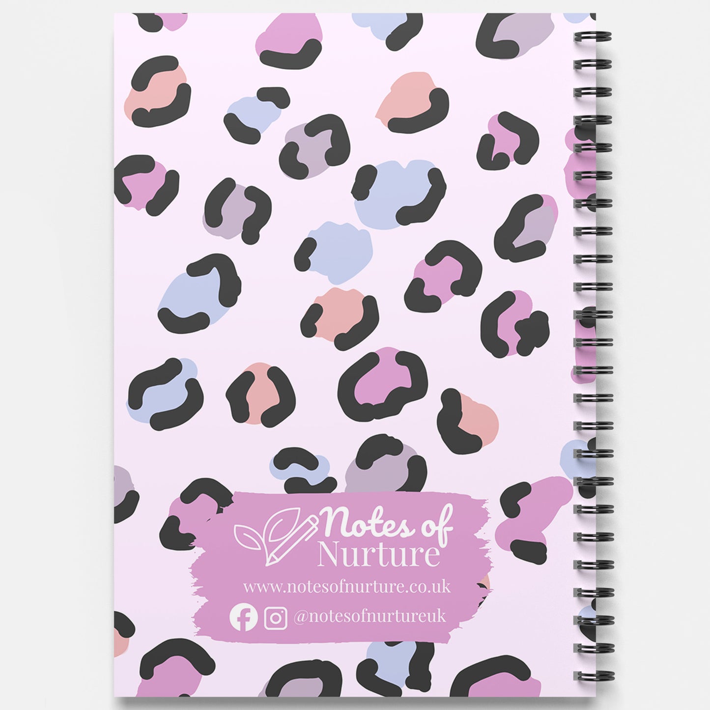 Notebook with pastel leopard print design and 'Notes of Nurture' branding on a light purple background.