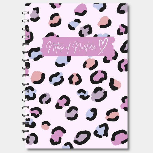 Notebook with pink and black leopard print cover and 'Notes of Nurture' text on a white background