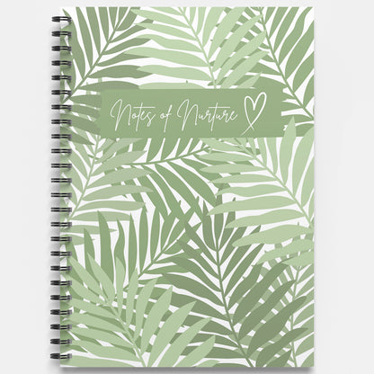 Notebook with green leaf pattern and 'Notes of Nurture' text on a white background