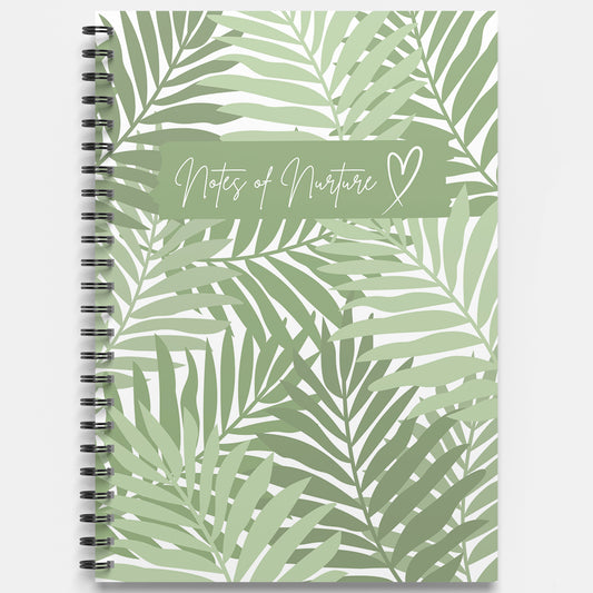 Notebook with green leaf pattern and 'Notes of Nurture' text on a white background
