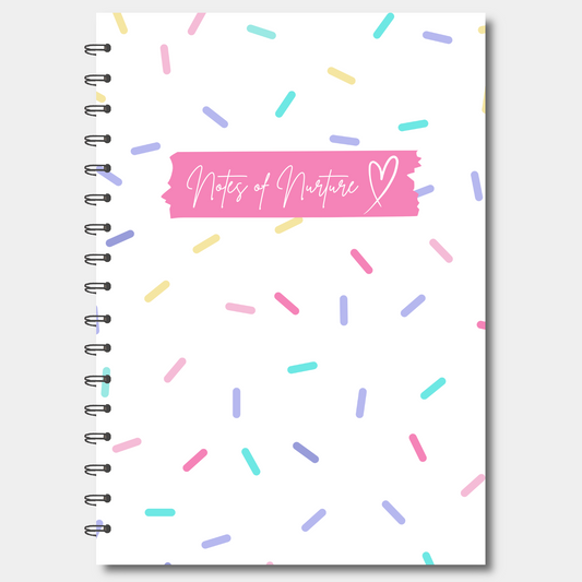 Notebook with colorful sprinkles and 'Notes of Nurture' text on a white background