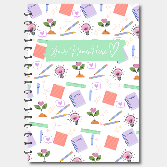 Notebook cover with colorful stationery items and 'Your Name Here' text
